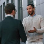businessman in formal clothes is with black man ou npl6cze