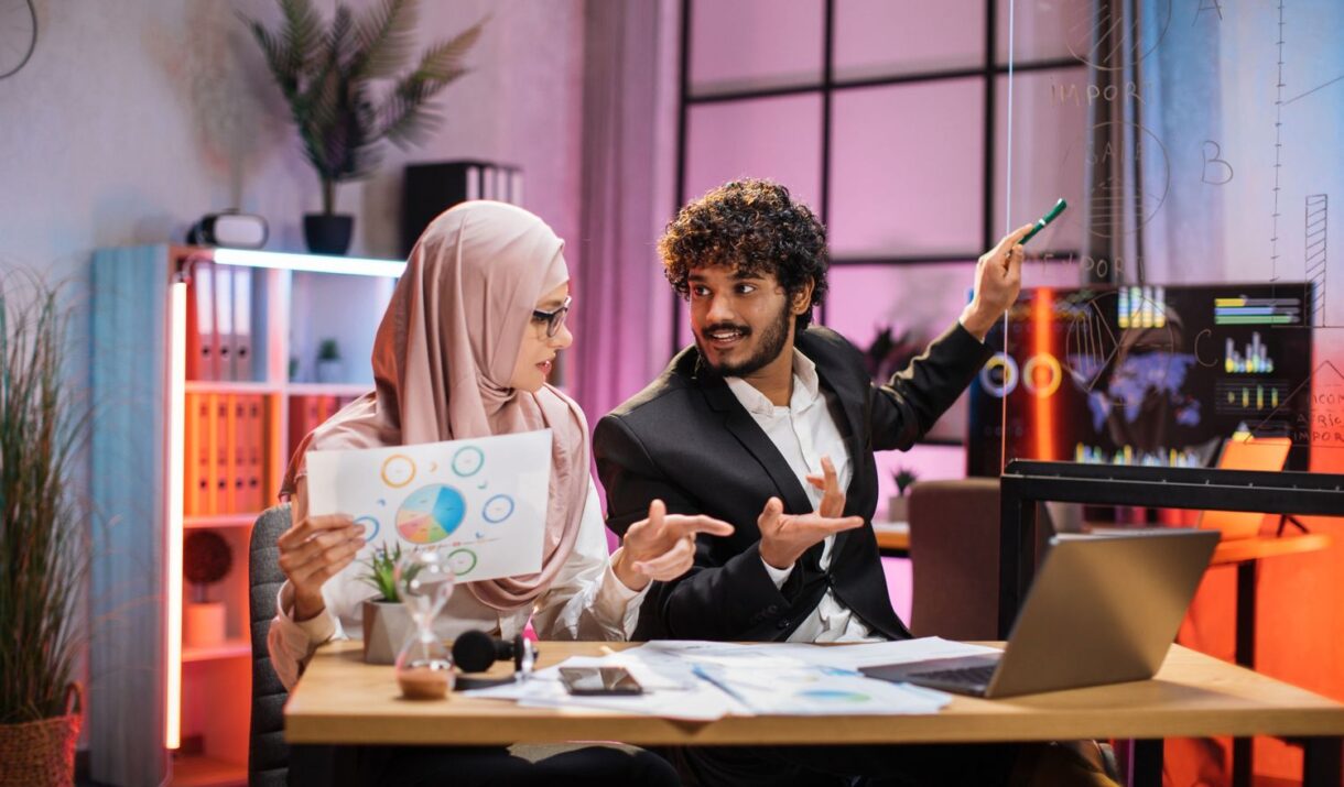 young businessman pointing on graphs and chart on m9lluxp