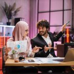 young businessman pointing on graphs and chart on m9lluxp